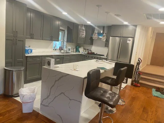 Kitchen with island and pendant lighting in Dix Hills, Suffolk County