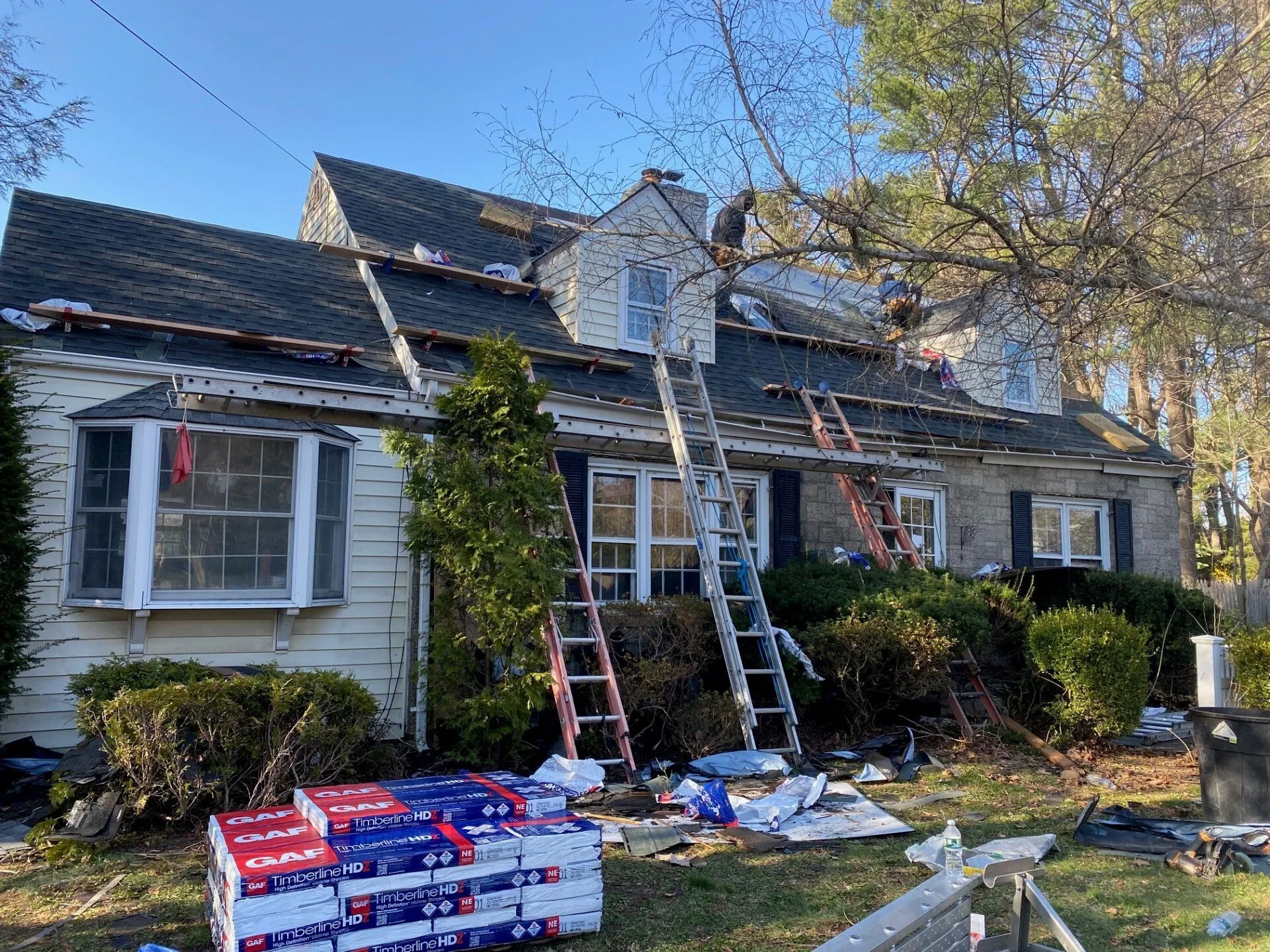 Roofing crew installing shingles on Long Island